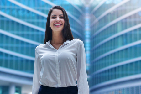 She is looking at the camera, she is proud of her work. Concept of: success, finance and female careerの写真素材