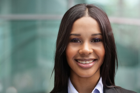 She is looking at the camera, she is proud of her work. Concept of: success, finance and female careerの写真素材