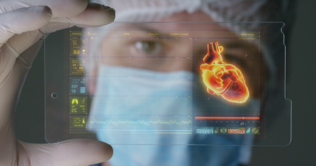 A futuristic physician, a surgeon, examines a technological digital holographic plate, a medical...