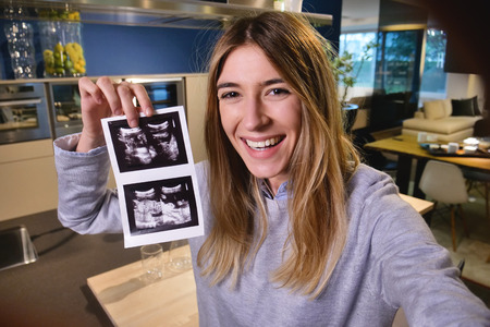 A woman is lying in bed, videochat with her husband and announces the birth of the child and then...