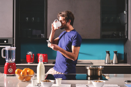 Tea or milk with a cup of tea and milk in the cup Concept of: social network, message, technology.の写真素材