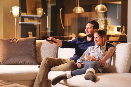 A couple of lovers watching television together. Concept of: leisure, relax, tv.の写真素材