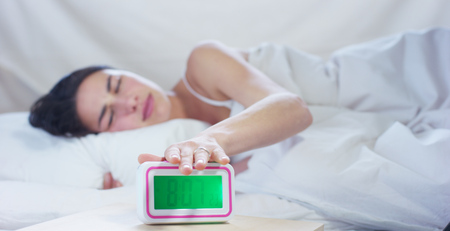 A simple day off for a beautiful young girl sleeping in a warm bed, on a white background.の写真素材