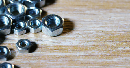 bolts and screws on a wooden work bench. concept of new screws or bolts. working tools in carpentry and home. and self-tapping steel screwsの写真素材
