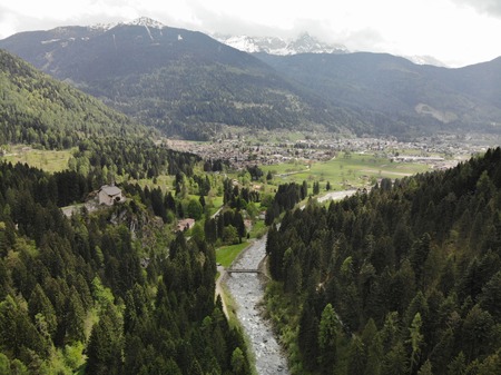 Aerial view of a waterfall surrounded by a magical, relaxing and green place.