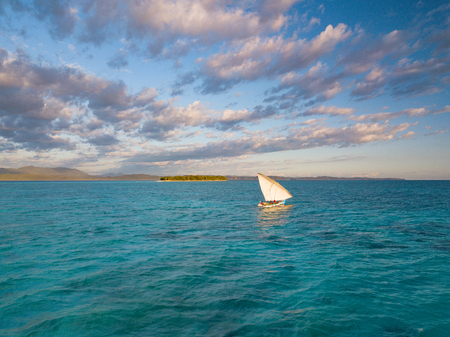 A boat travels in the open ocean, among islands, underwater animals. A journey of exploration,...