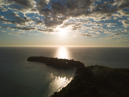 Aerial view of a magnificent sunset with palm trees. Wonderful places for a dream vacation. Concept of: holiday, wild, nature.の写真素材