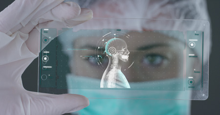 A futuristic doctor with syringe withdraws at liquid medicine and appears at hologram of a planet.の写真素材