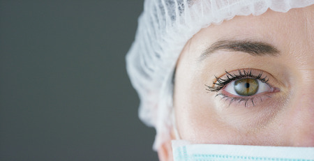 close up portrait of a woman surgeon or doctor with mask ready for operation in hospital or clinic.の写真素材