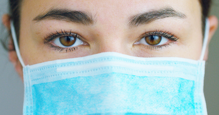 close up portrait of a woman surgeon or doctor with headset ready for operation in hospital or clinic.の写真素材