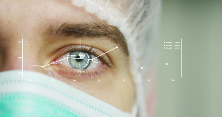 close up or macro of an eye of a doctor, surgeon. futuristic and technological vision of medical...