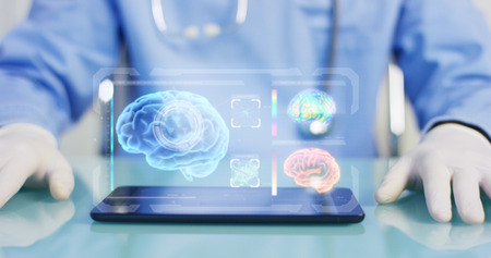 A physician, surgeon, examines a technological digital holographic plate. Concept: Futuristic medicine, the human body, and the future, brainの写真素材