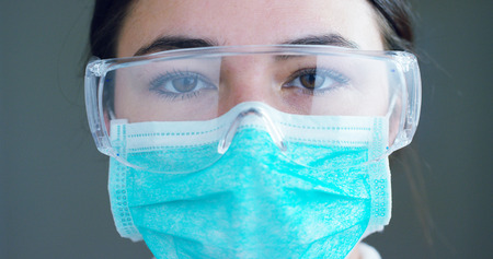 close up portrait of a surgeon or doctor with mask and headset ready for operation in hospital or clinic.の写真素材
