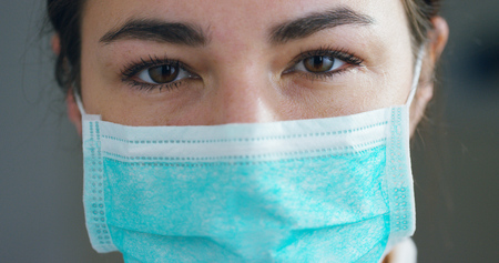close up portrait of a woman surgeon or doctor with headset ready for operation in hospital or clinic.の写真素材