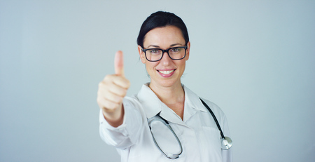 Portrait of female doctor with stethoscope looking at camera. Concept: doctor, health care, love of medicine.の写真素材
