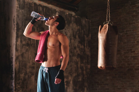 A boy finished the exercise with the water. Concept of: purity, hydration, sport,