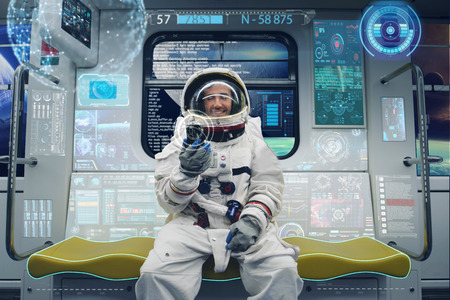 An astronaut sitting on the space shuttle. Concept of: holography, future, astronautの写真素材