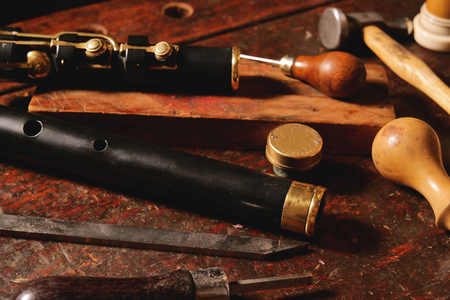 Composition of tools that a craftsman uses to build sweet flutes and crosspieces, made exclusively by hand and precious wood or ivory, in his own laboratory. Concept of: music, traditionの写真素材