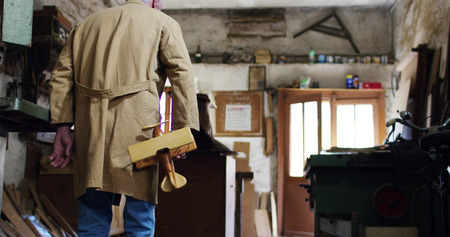 in an old carpentry shop a child and grandfather playing with a wooden airplaneの写真素材