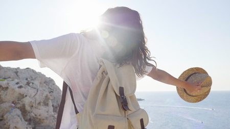 Walks with the backpack, walks along the rocks, the sea and mountains. Concept: recreation, beautiful view, sports.の写真素材