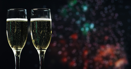 Champagne toast while in the background break out the fireworks. Concept: new year, love, holidays, party.の写真素材