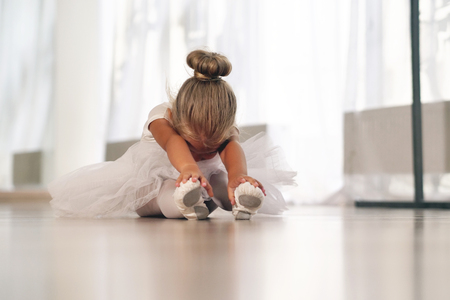 Train of a beautiful young girl, in a dance school wearing a white tutu. Concept of: ambition, education, elegance and love for the dance ...の写真素材