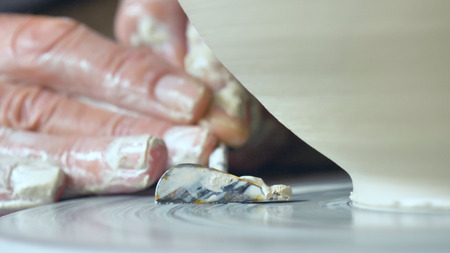 In a creative laboratory, an old handmade craftsman clay and mold to create home-made jars and artwork. Concept of: handcraft, tradition, handmade artwork, creativity.の写真素材