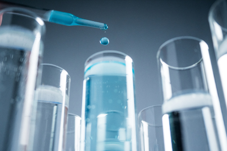 In a futuristic laboratory, a scientist with a pipette and a liquid to extract the DNA and molecules in the test tubes. Concepts: research, biochemistry, immersive technology, augmented realityの写真素材