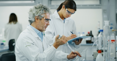 DNA and molecules in the test tube and signs in laboratory. Concept: research, biochemistry, pharmaceutical medicineの写真素材