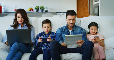 Portrait of happy family having fun in modern living room in slow motion. Concept of family...