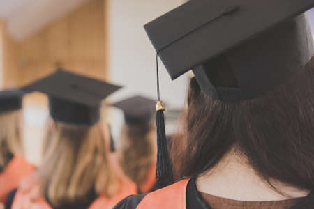 Women graduates of the university in square academic caps during graduation ceremony. Congratulation concept for graduates of university.の写真素材