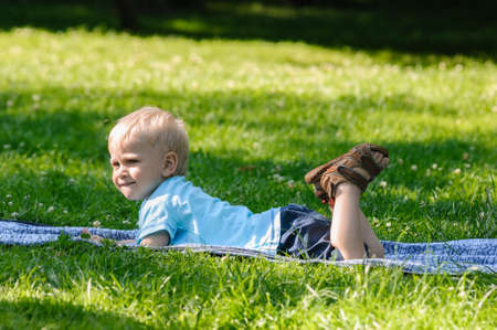 portrait of playing boy on grass in gardenの写真素材