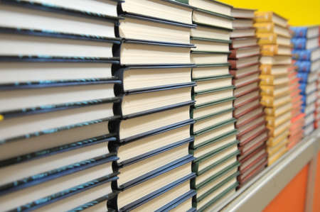 piles of new books in horizontal line in bookstore (Shallow depth of field)