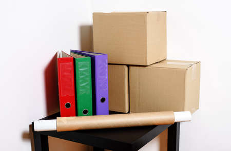 Moving day - cardboard boxes with table and files in roomの写真素材