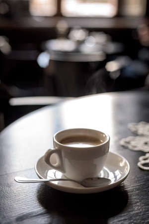 coffee cup on black wooden table in cafe