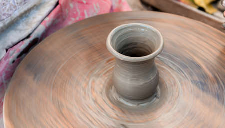 manufacturing of Ukrainian traditional handmade ceramic pot on the wheel