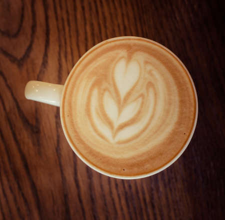 cappuccino cup on the brown wooden table