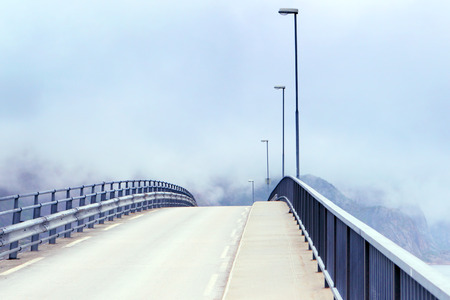 Open road.The bridge in fogの写真素材
