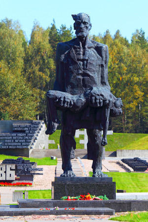 KHATYN, BELARUS- 16 September ,2014:Monument \"The unsubdued person\" (the man with the dead child on hands) in Khatyn, Belarus on September 16, 2014.\"Khatyn\" - a monument to the victims of Nazism.のeditorial素材