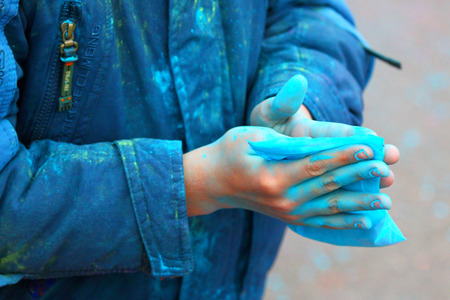 Gatchina,Leningrad region,Russia-29 September, 2013:A package with paint in hands of the young man in Gatchina, the Leningrad region, Russia,29 September,2013. Festival of paints.のeditorial素材