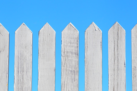 Wooden fence. Background of the blue sky.の写真素材