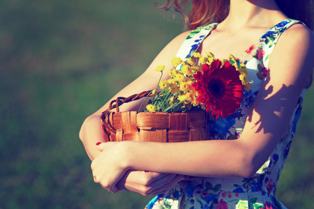 Basket of flowers.Photo toned in retro style.の写真素材