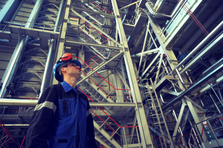 Engineer working in the industrial interior.Photo toned in retro style.の写真素材