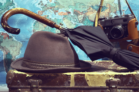 Hat, umbrella, camera, card, suitcase. Background travel.Photo toned in retro styleの写真素材
