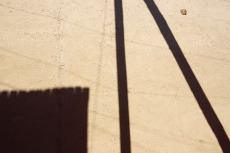 Shadows on the clay wall. Abstract background.の写真素材