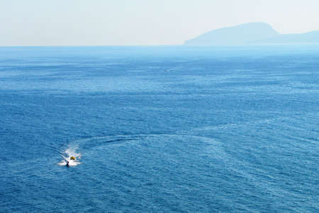 Vacationers ride on boats in the waters of the black sea bay in Crimea
