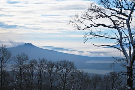 Ruins of an ancient castle in the dark mountainsの写真素材