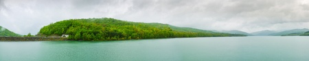 Panorama of reservoir coast and rainy skyの写真素材