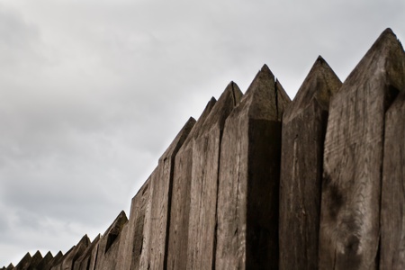 Top part of old wooden stockade on historic fortificationの写真素材