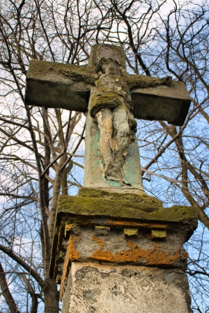 Wayside cross in countryside between trees with dramatic skyの写真素材
